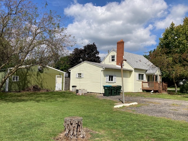 a front view of a house with a garden and yard