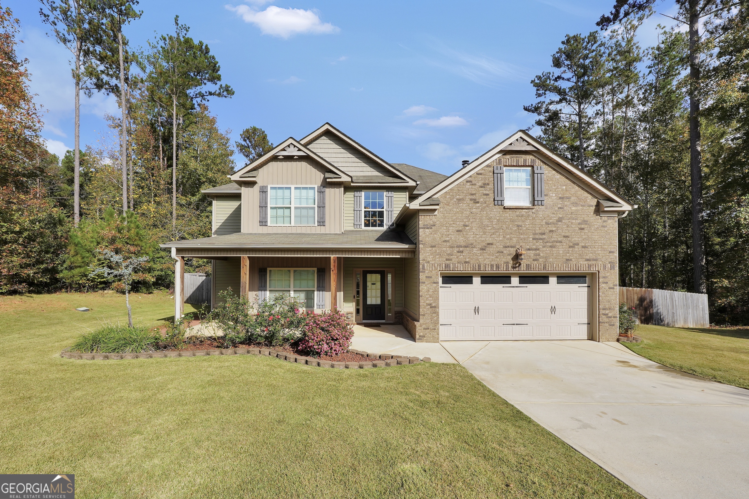 a front view of a house with garden