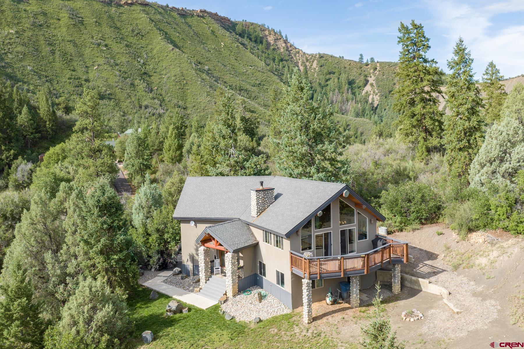 an aerial view of a house with a yard