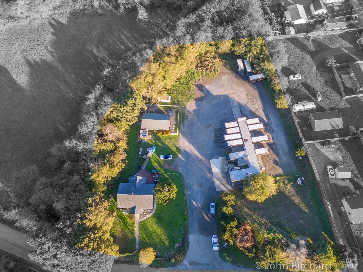 an aerial view of residential houses with outdoor space