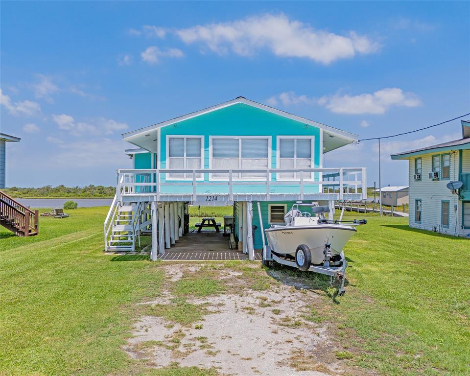 a view of a house with backyard porch and sitting area