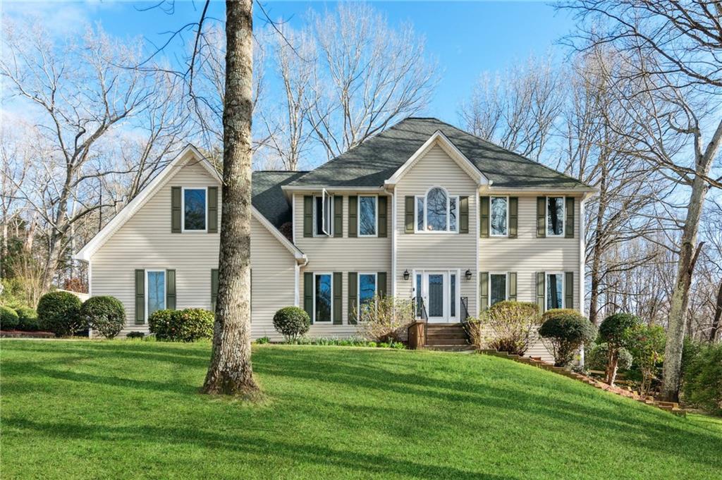 a front view of a house with a garden