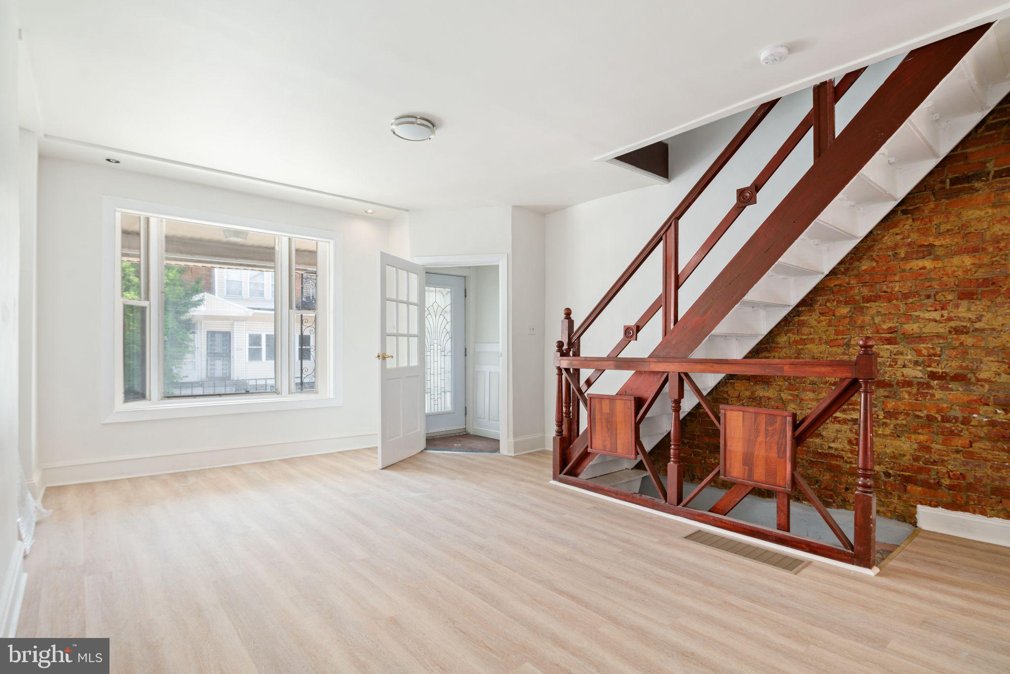 a view of an entryway with wooden floor