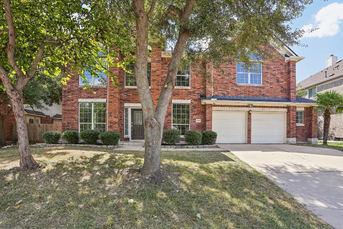 a front view of a house with a yard and garage