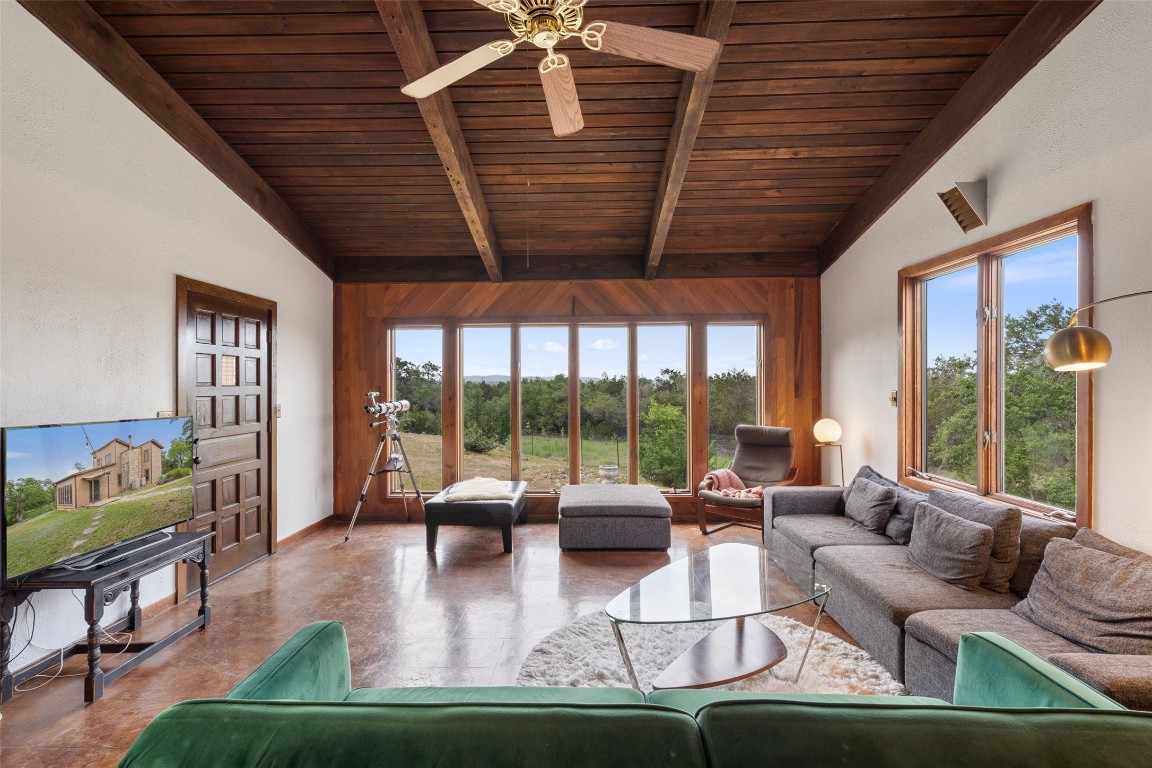 a living room with fireplace furniture and a large window