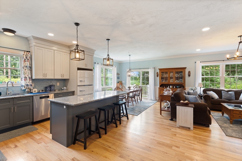 a large kitchen with lots of counter space a sink appliances and dining table