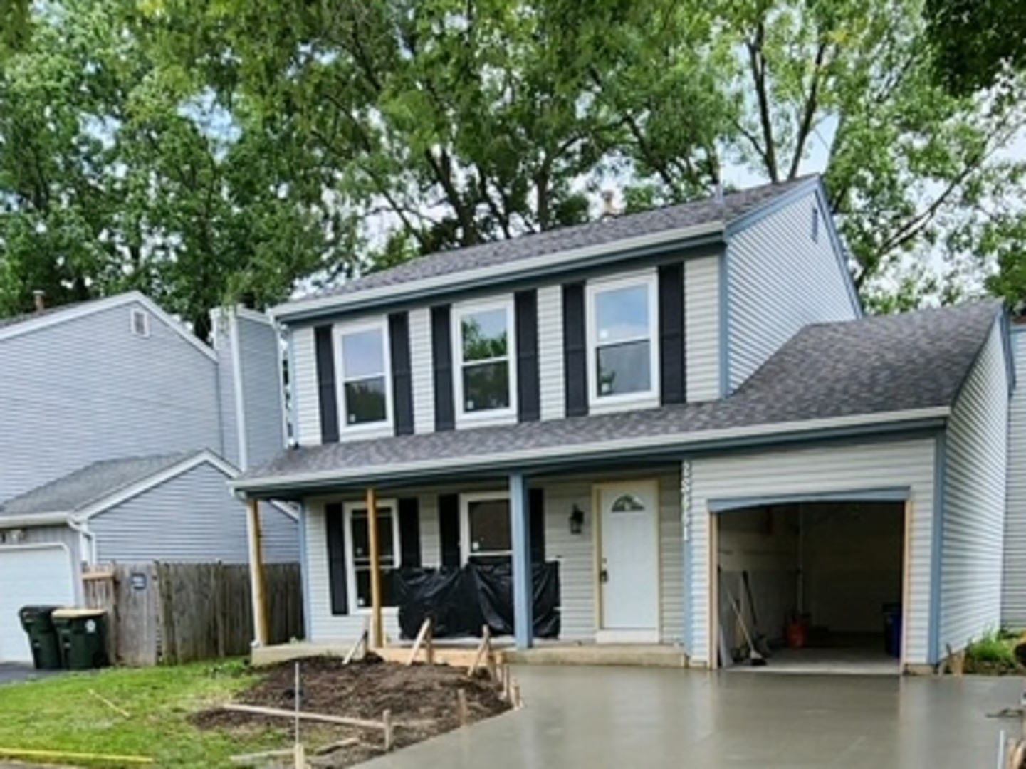 a front view of a house with garden and porch