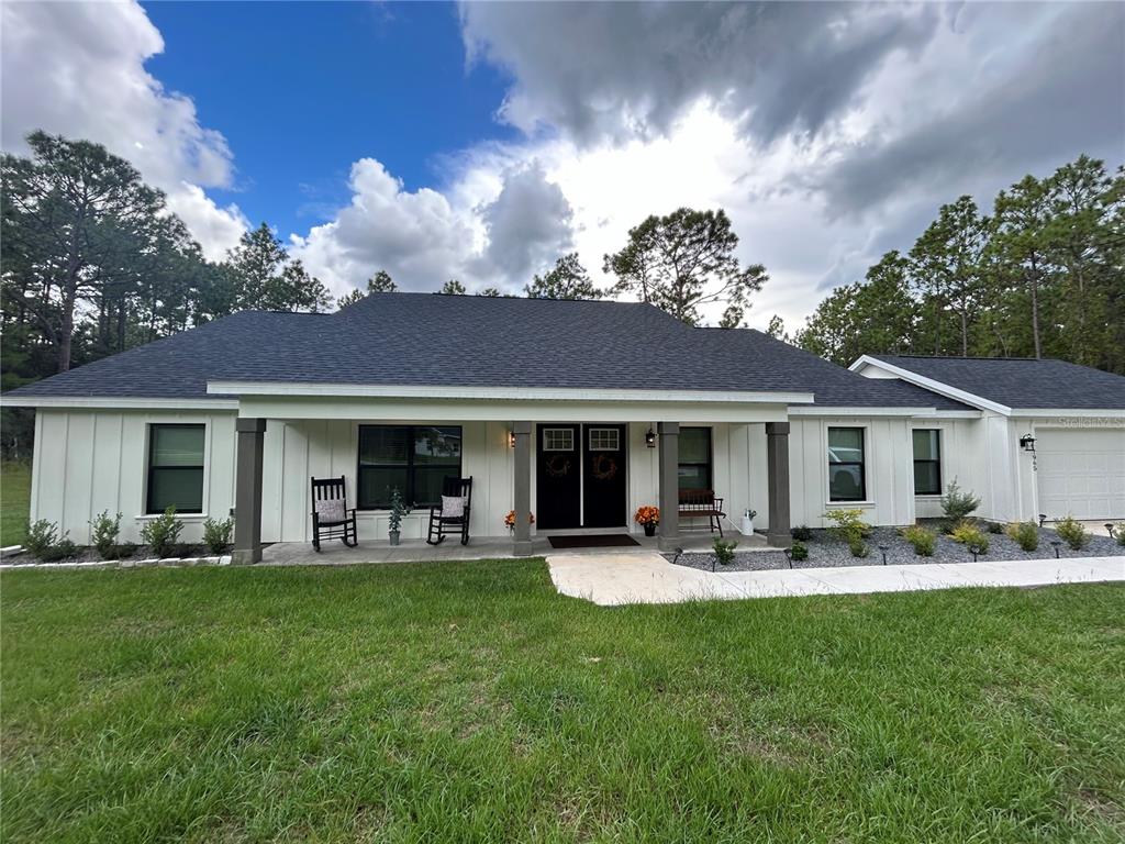 a front view of house with yard and outdoor seating