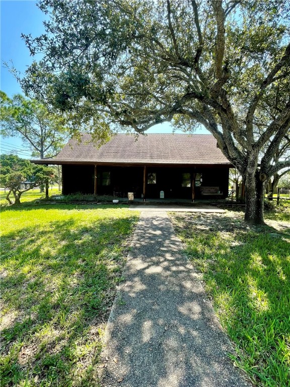 a view of house with yard