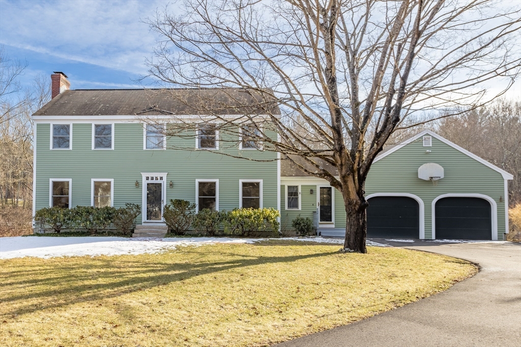 a front view of a house with a yard covered in snow