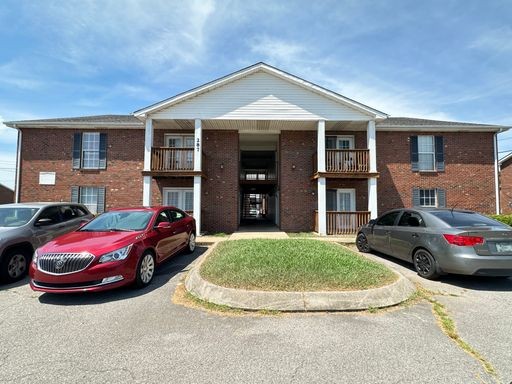 a front view of a house with parking space