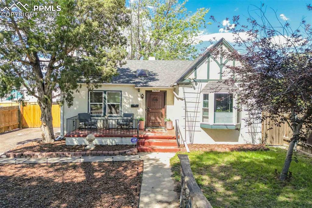 Front view of this 1938 Stucco Ranch Home. Showing front yard