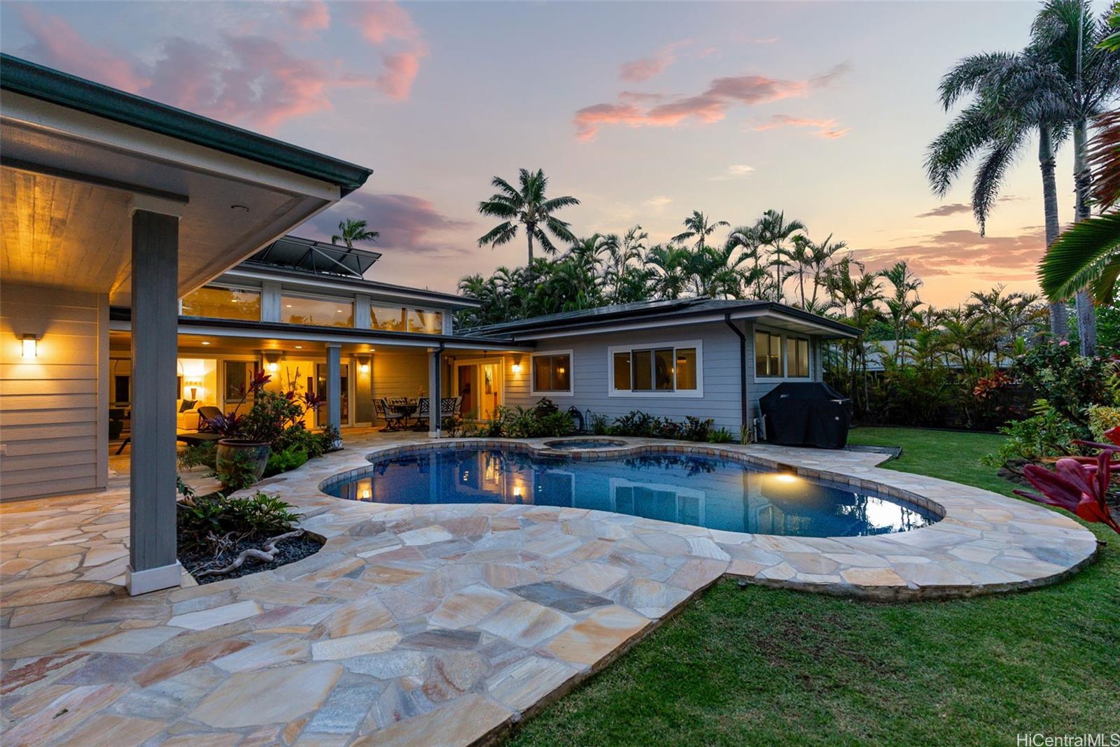 a view of a house with swimming pool and sitting area