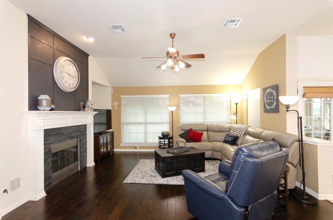 Spacious family room has hardwood flooring & updated gas log fireplace