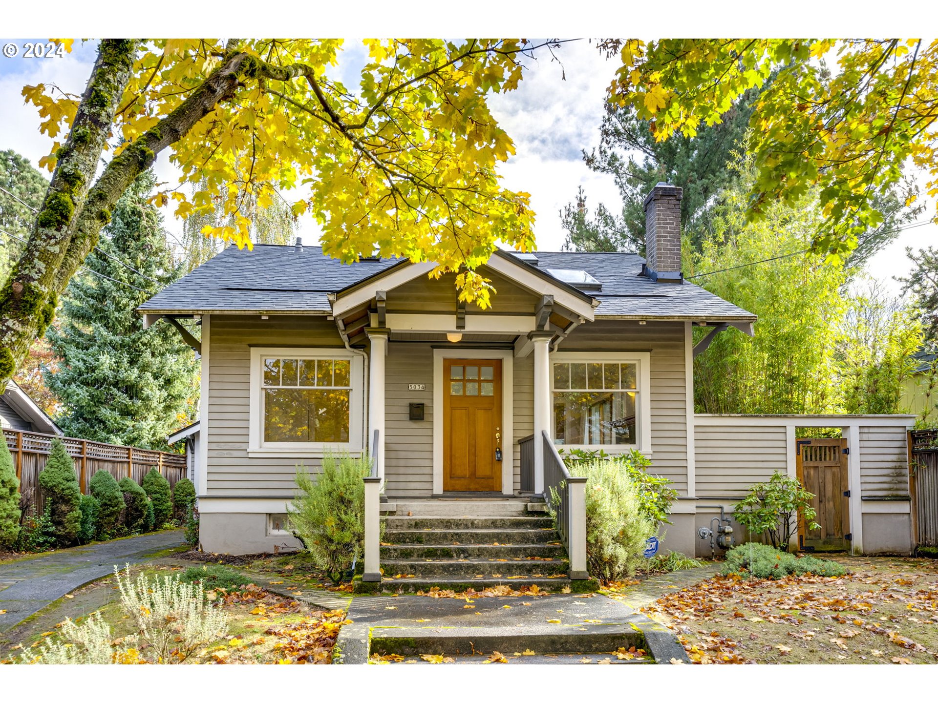 a view of a house with a small yard and plants