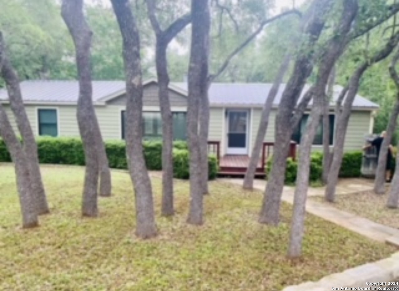 a view of a house with backyard and sitting area