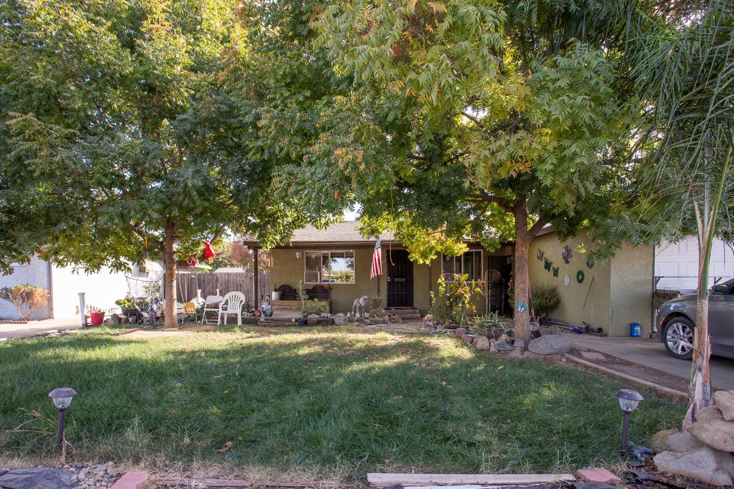 a view of a patio with table and chairs under an umbrella