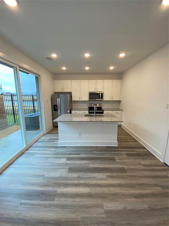 a view of kitchen with wooden floor