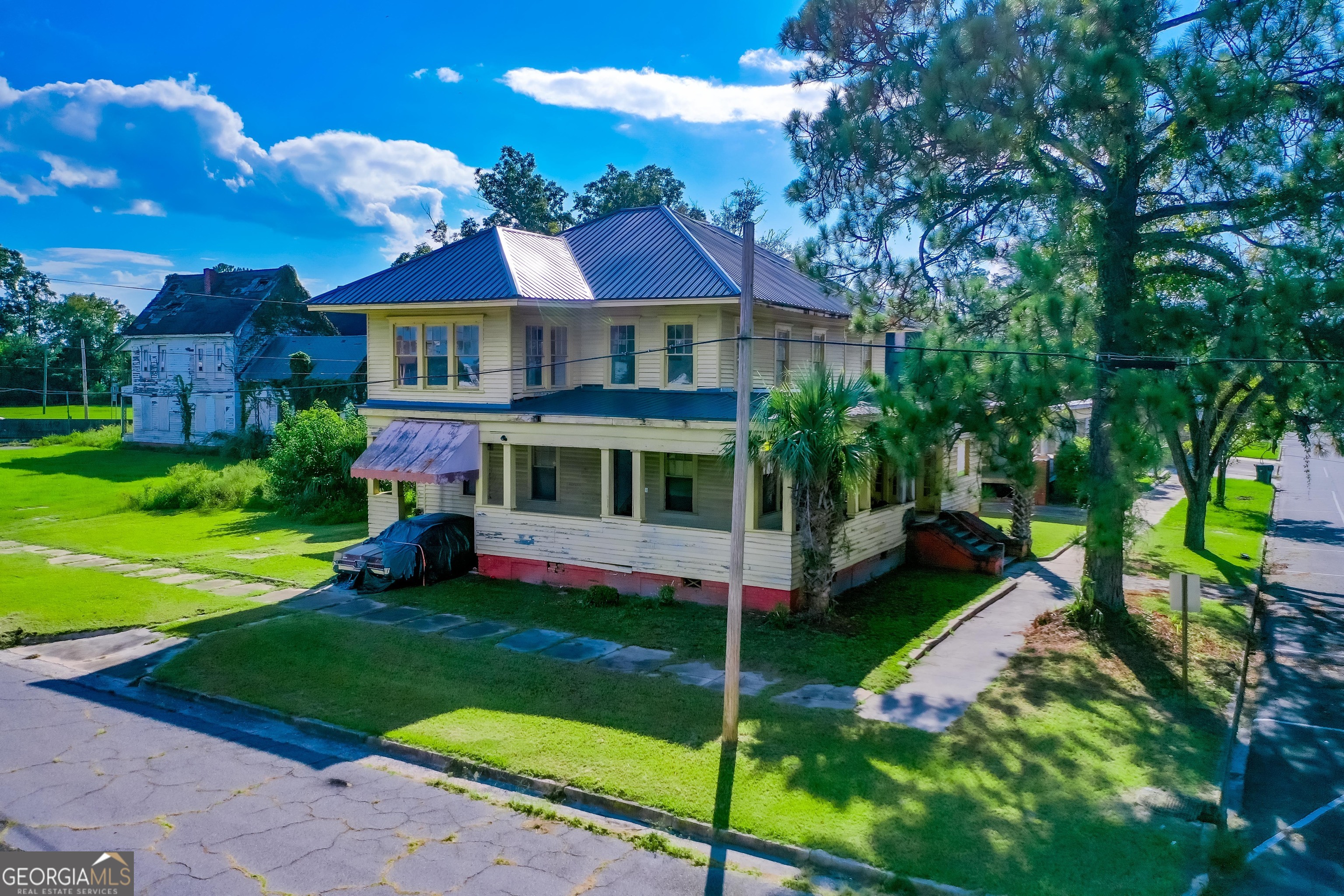 a front view of house with yard and green space