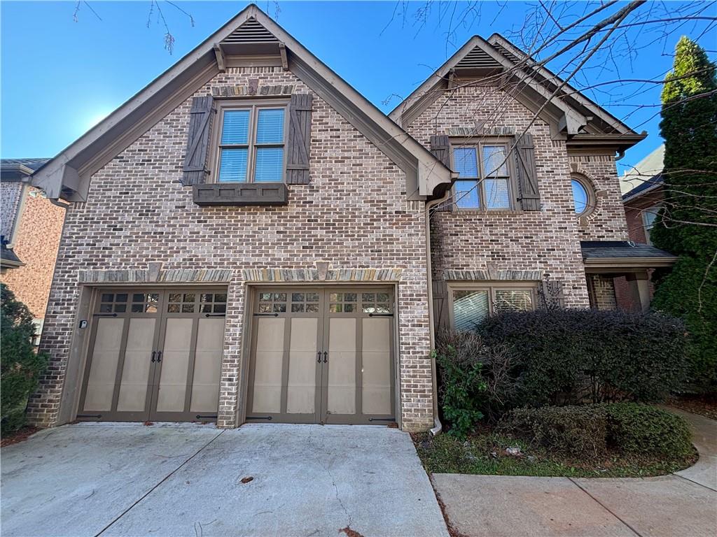 a front view of a house with garage