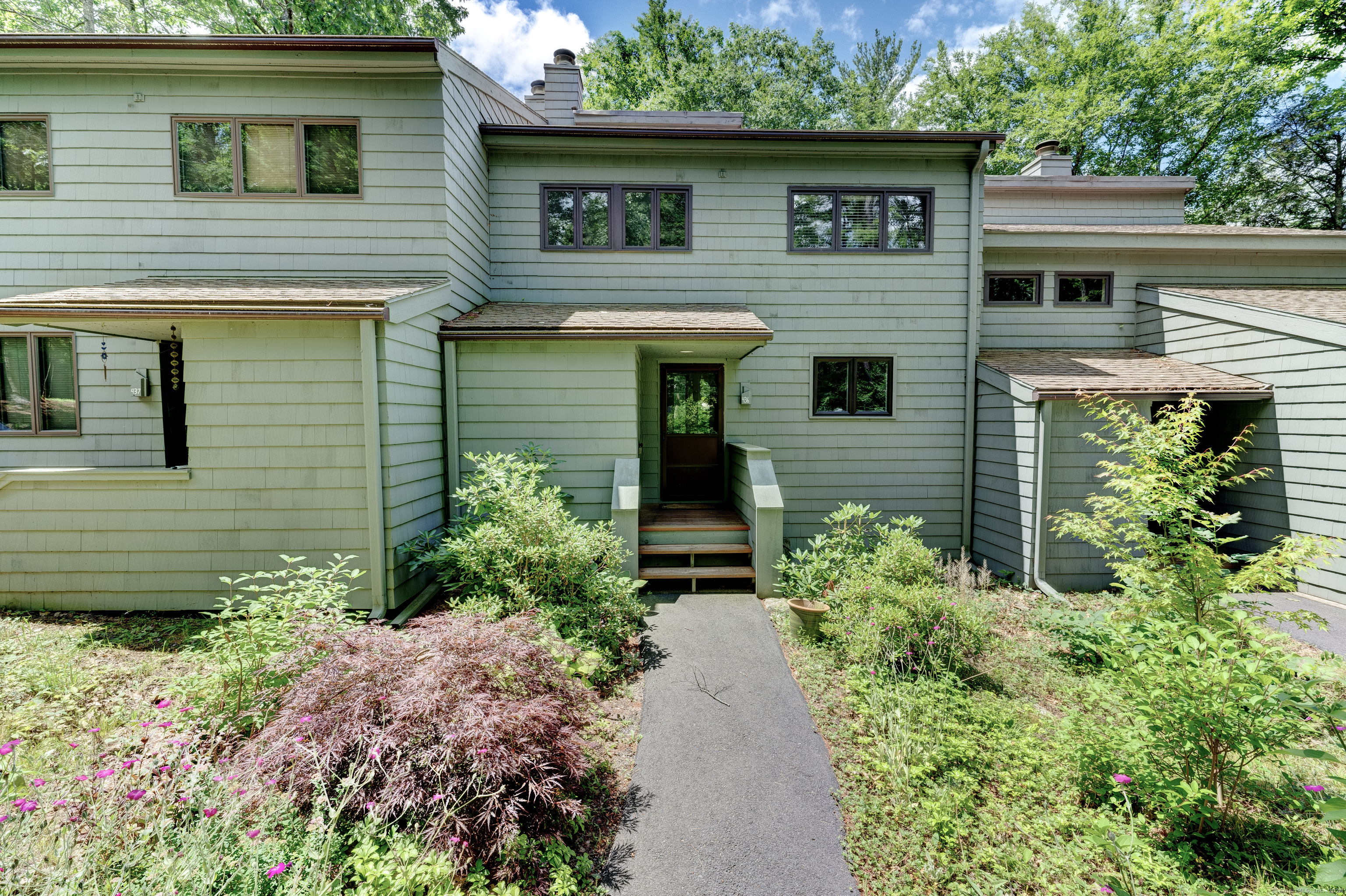 a front view of a house with garden