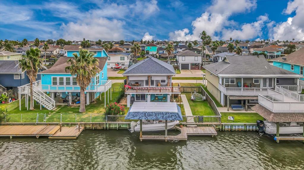 an aerial view of a house with a garden and lake view