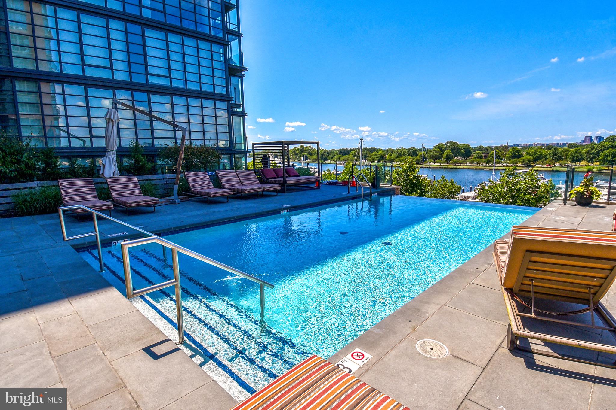 a swimming pool with outdoor seating and yard