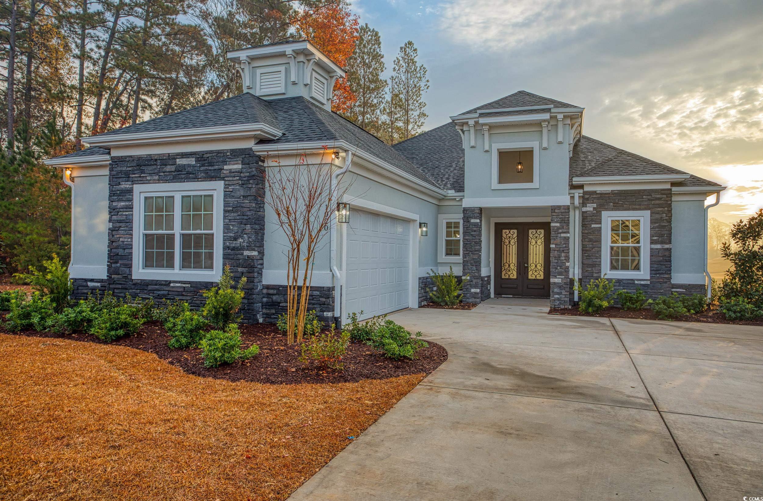 View of front of home featuring a garage and frenc