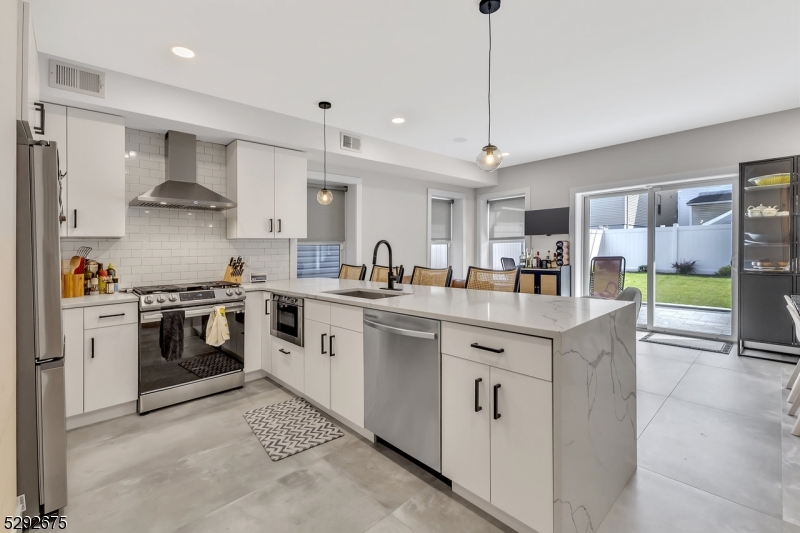 a kitchen with stainless steel appliances granite countertop a sink and cabinets