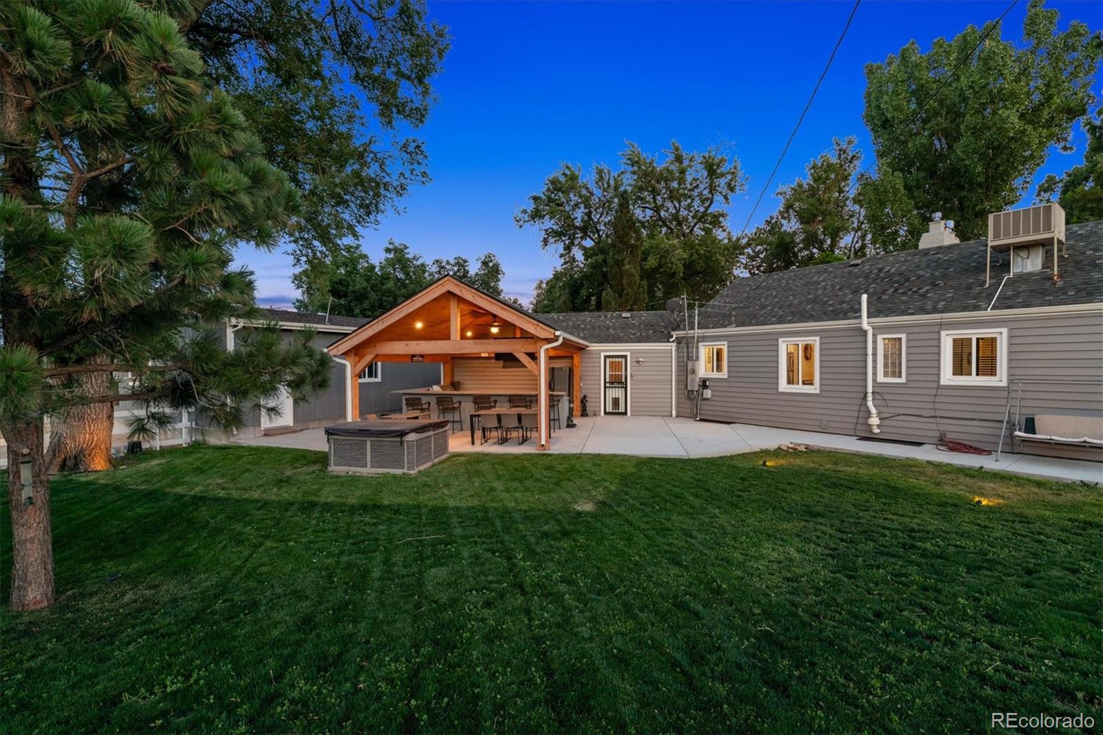 a front view of a house with yard and green space