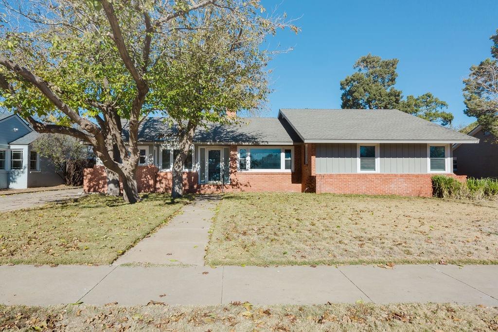 front view of a house with a tree