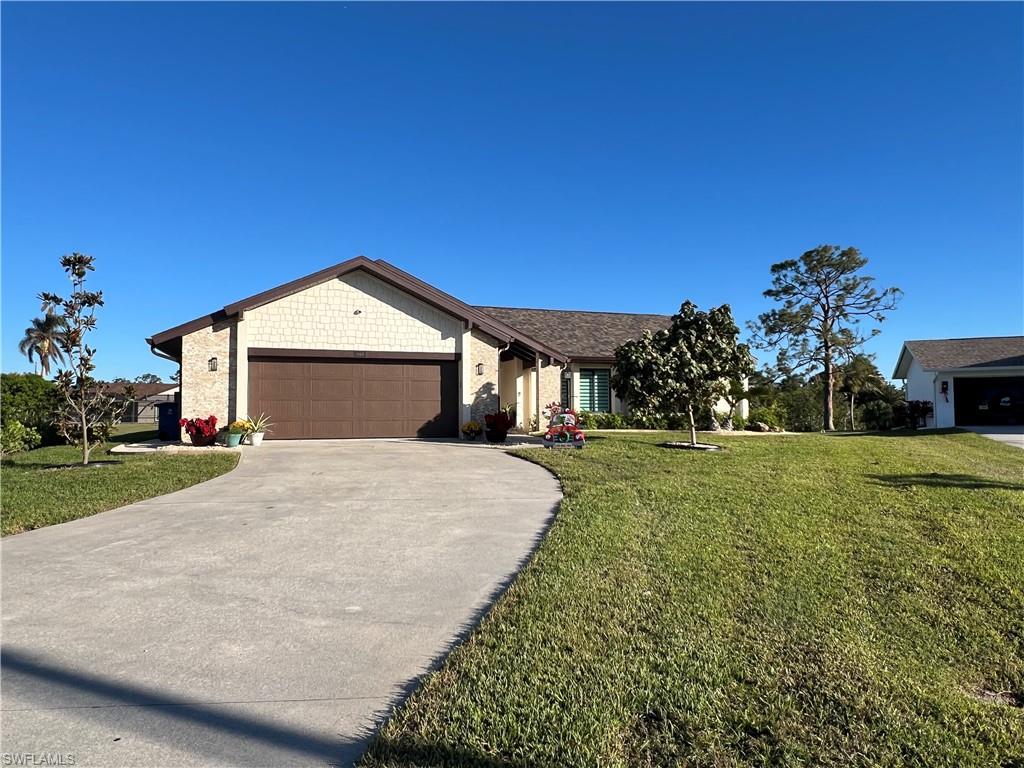 a front view of a house with a yard and garage