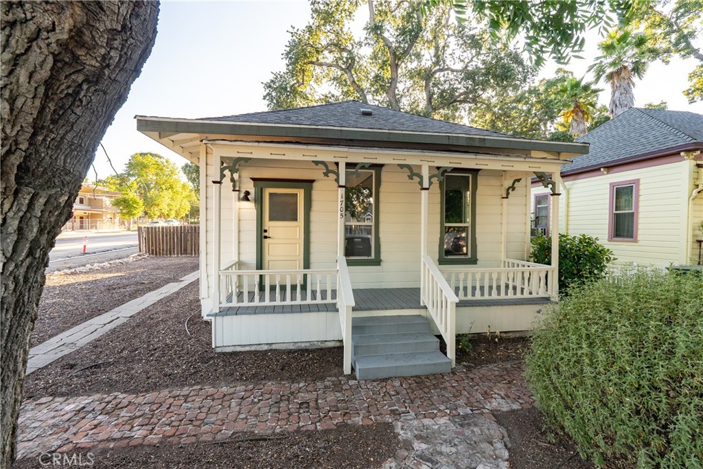 a view of a house with a bench and floor to ceiling window