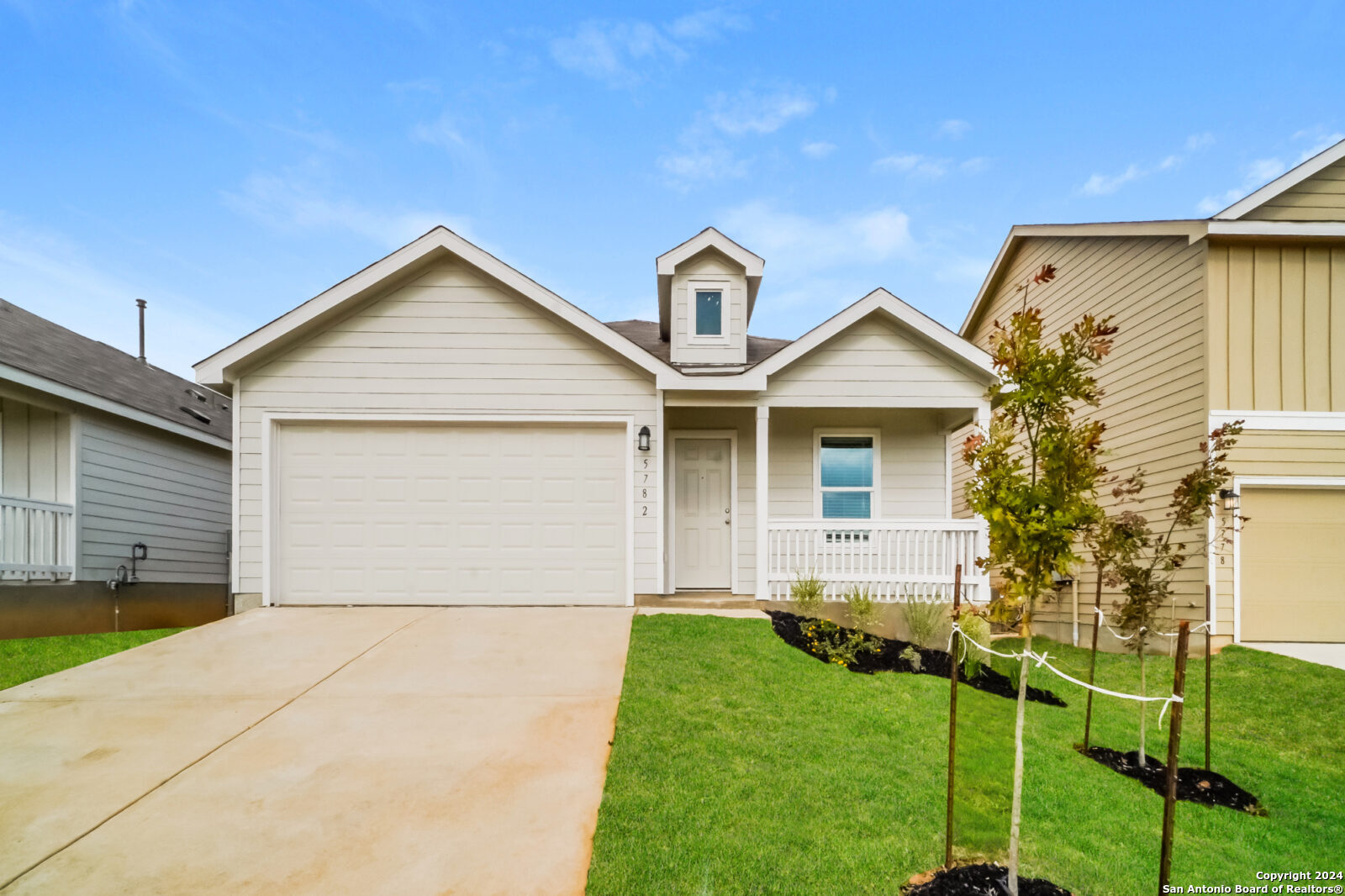 a front view of house with yard and green space