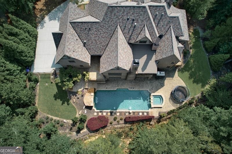 an aerial view of a house with garden space and street view