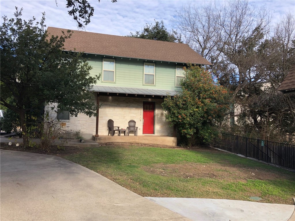 a view of a house with a yard and garage