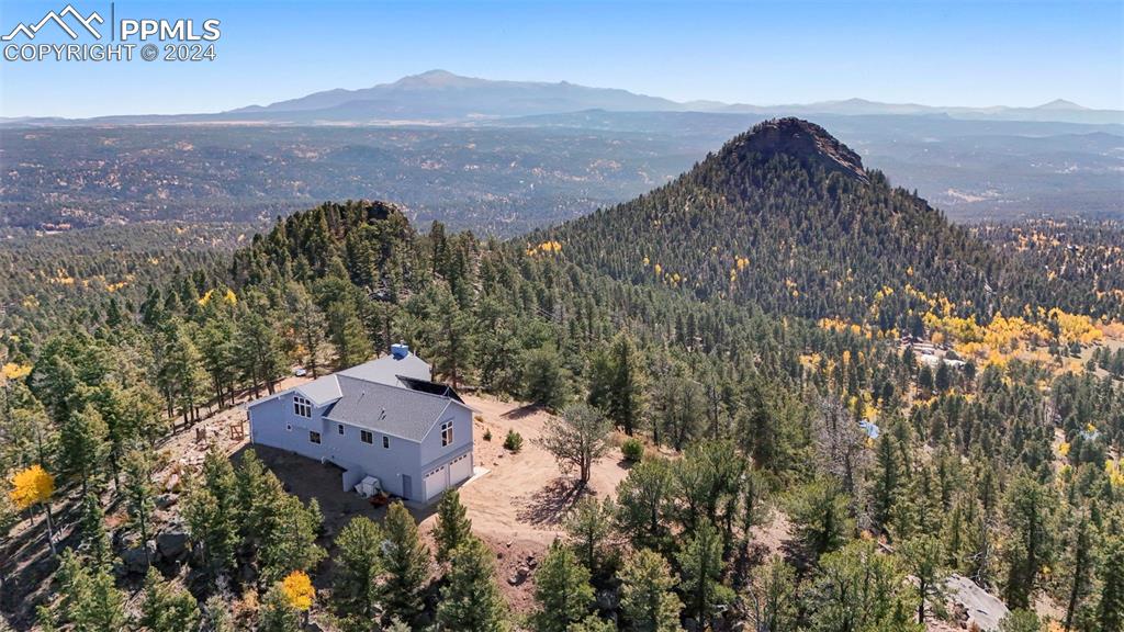 an aerial view of houses with a mountain