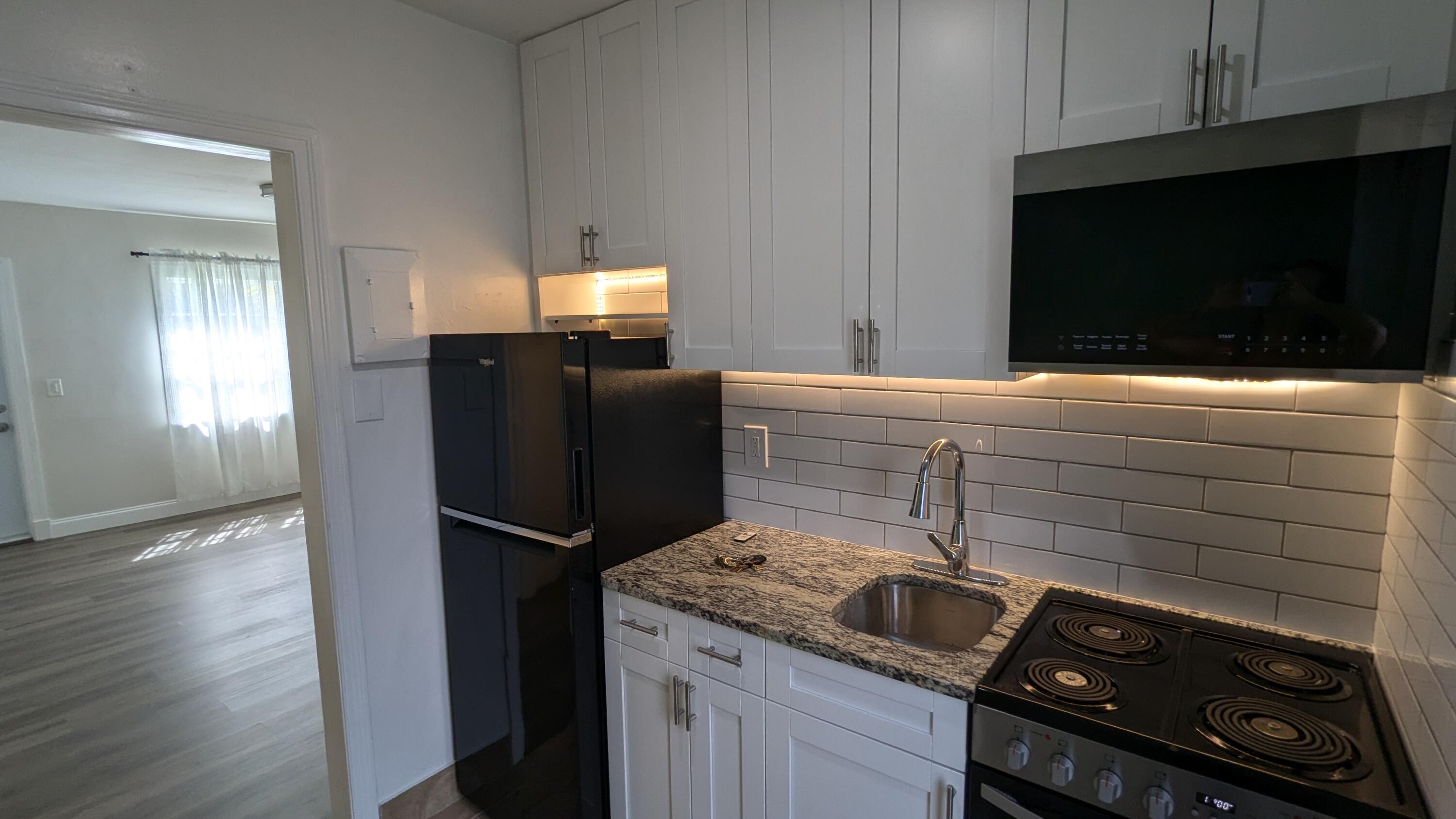 a kitchen with a refrigerator and a microwave