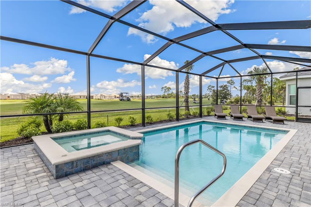 swimming pool view with a seating space