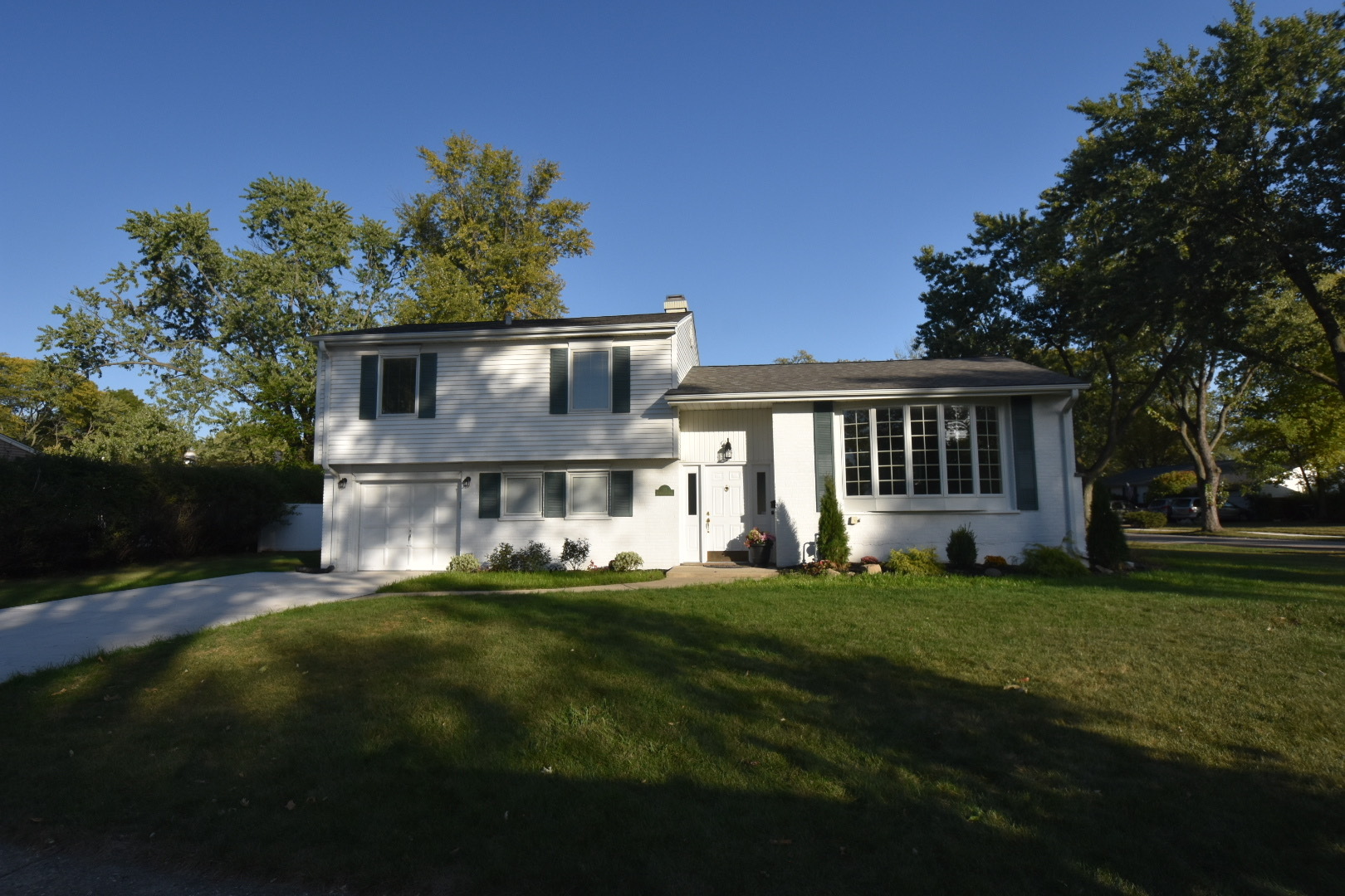 a front view of house with yard outdoor seating and green space