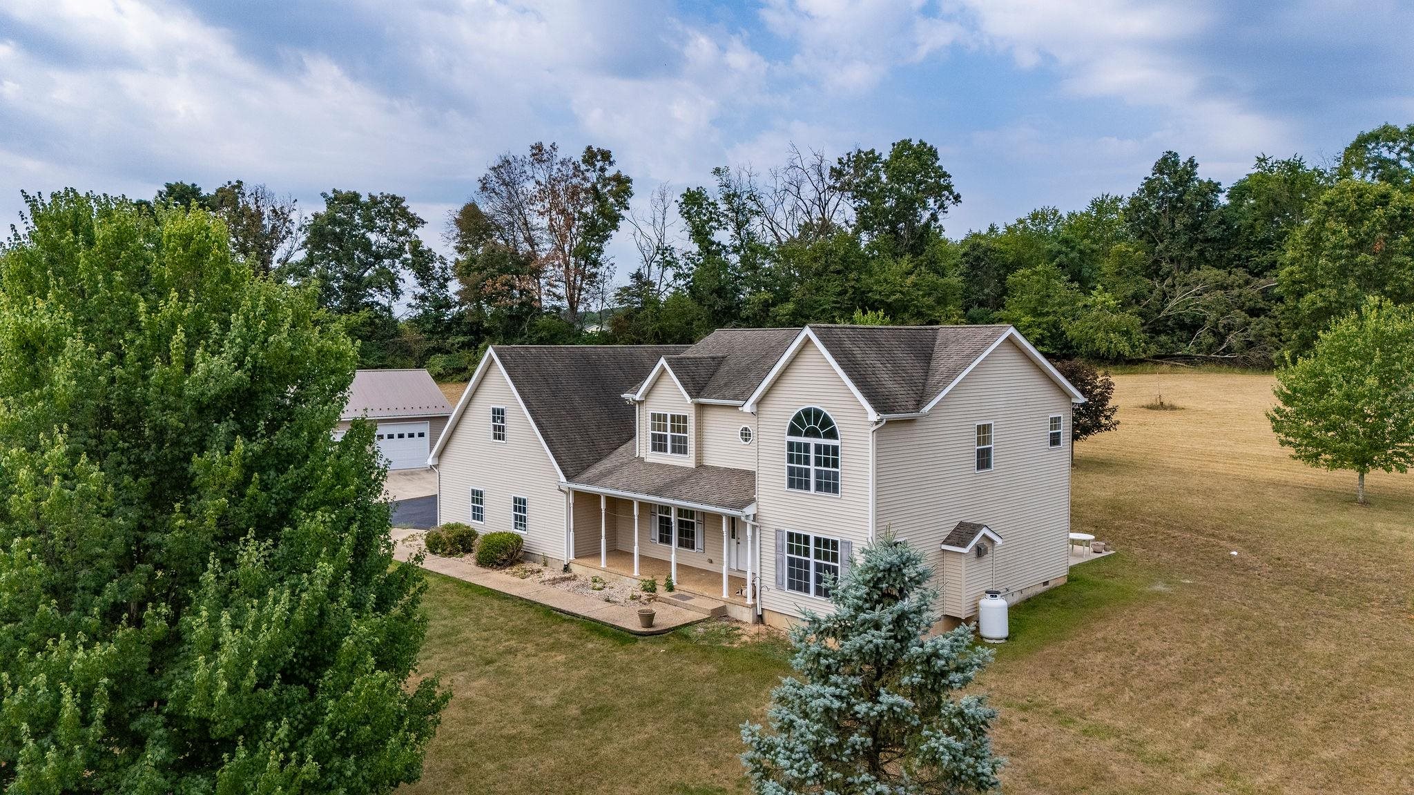 an aerial view of a house with a yard