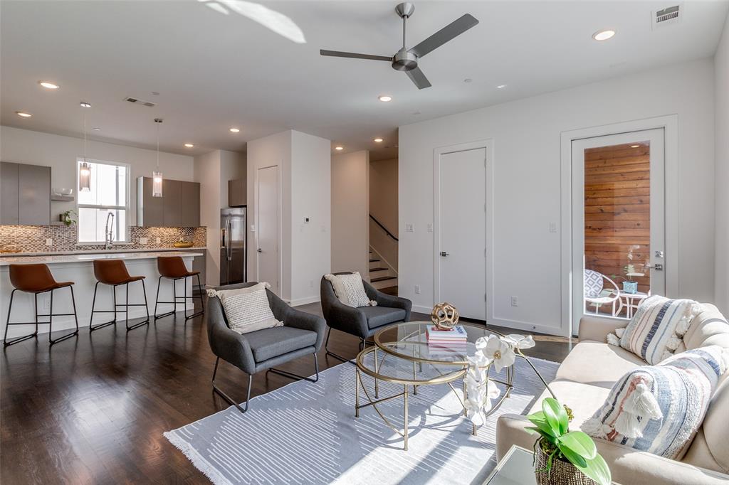 a living room with furniture and wooden floor