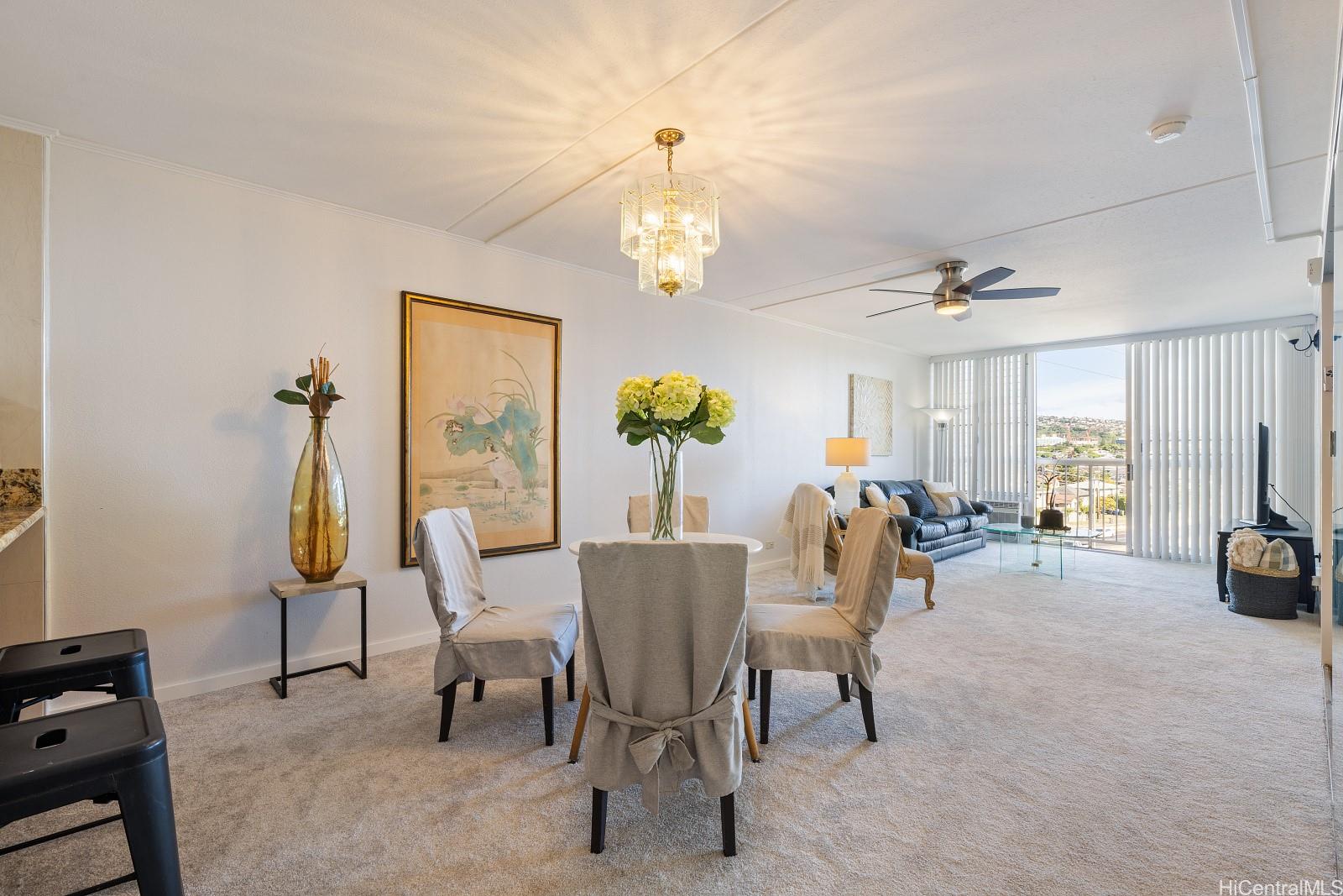 a view of dining room and livingroom with furniture wooden floor a chandelier