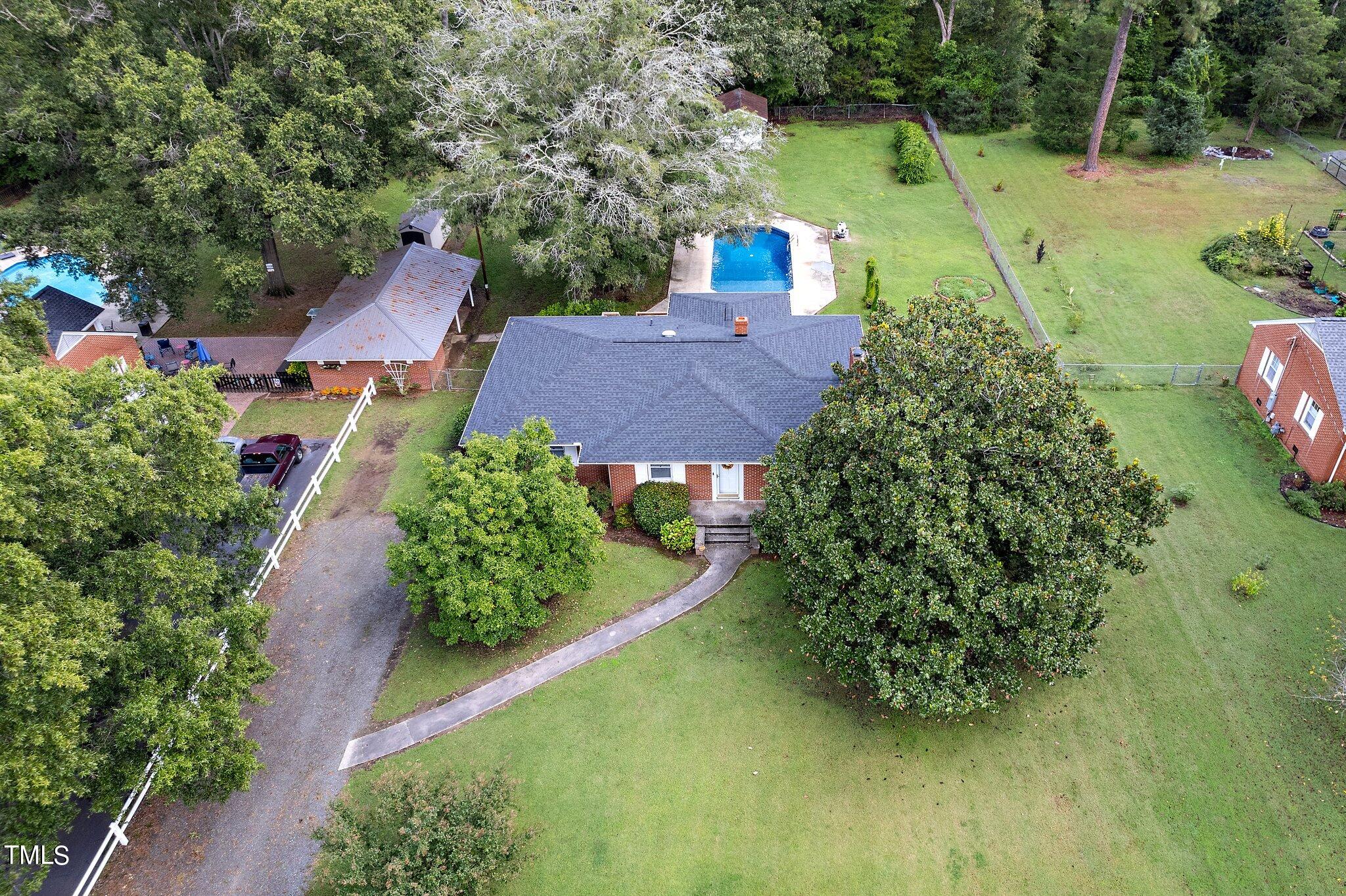 an aerial view of a house with garden space and street view