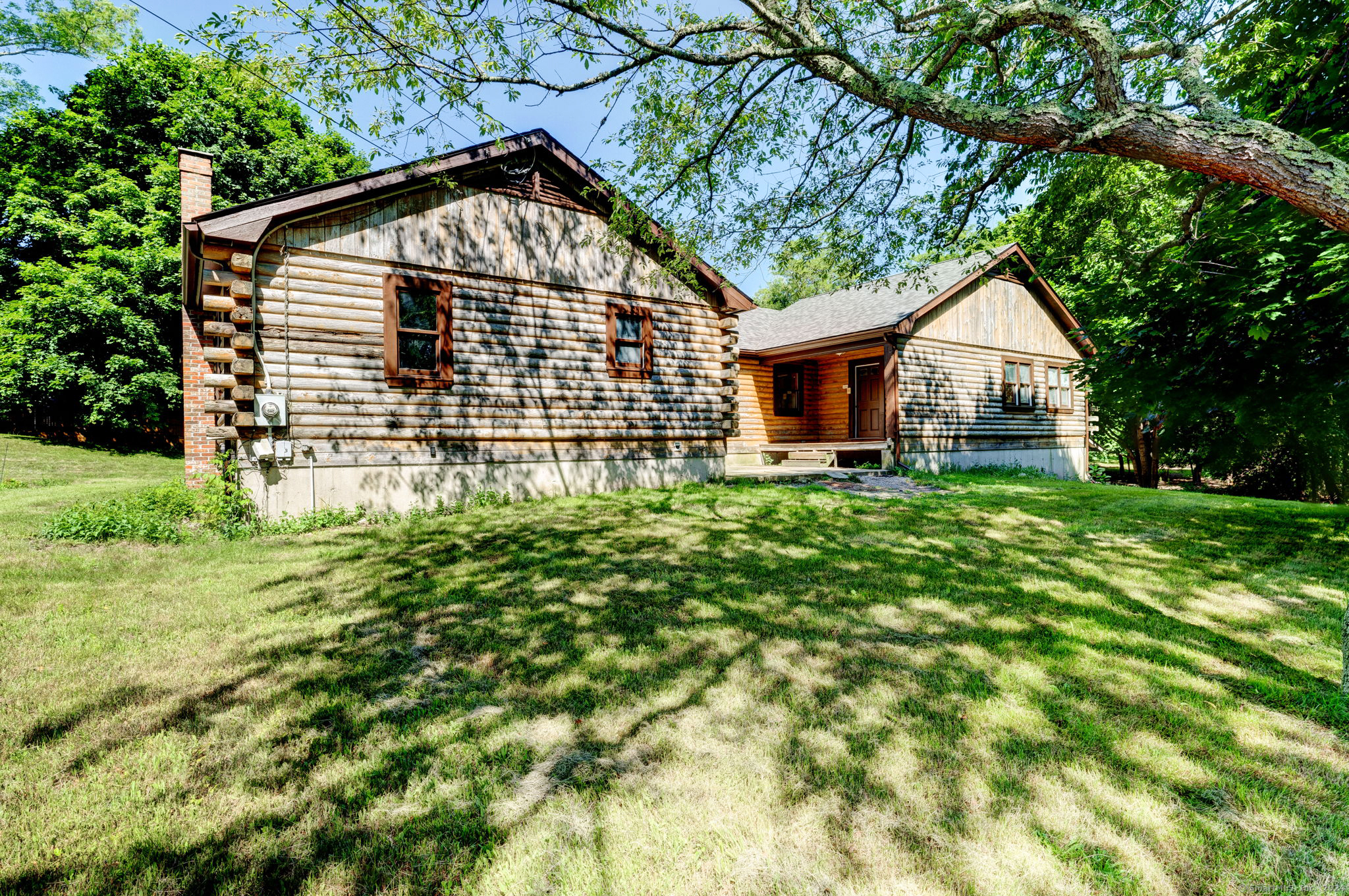 a view of house with backyard