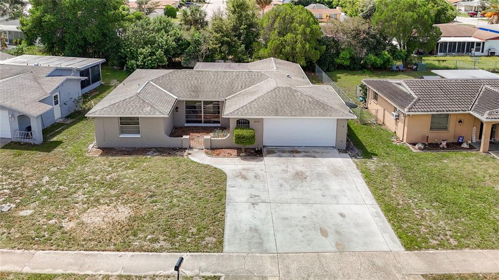 an aerial view of a house with yard patio and trees