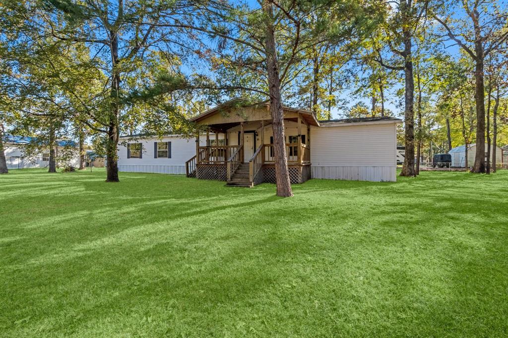 a view of a house with yard and tree s