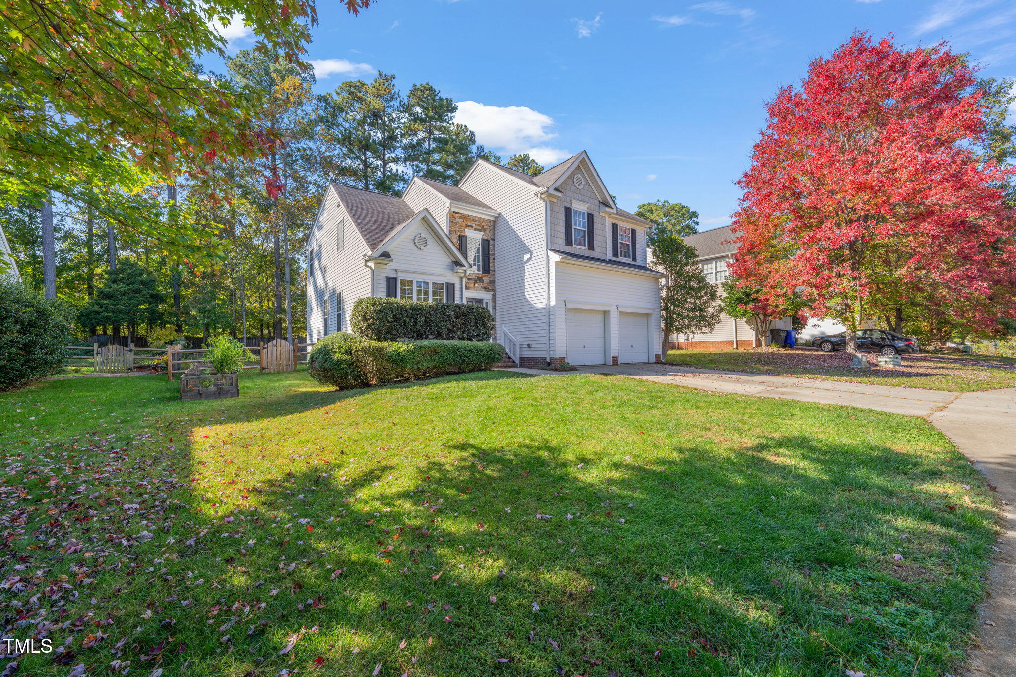 a front view of house with yard and green space