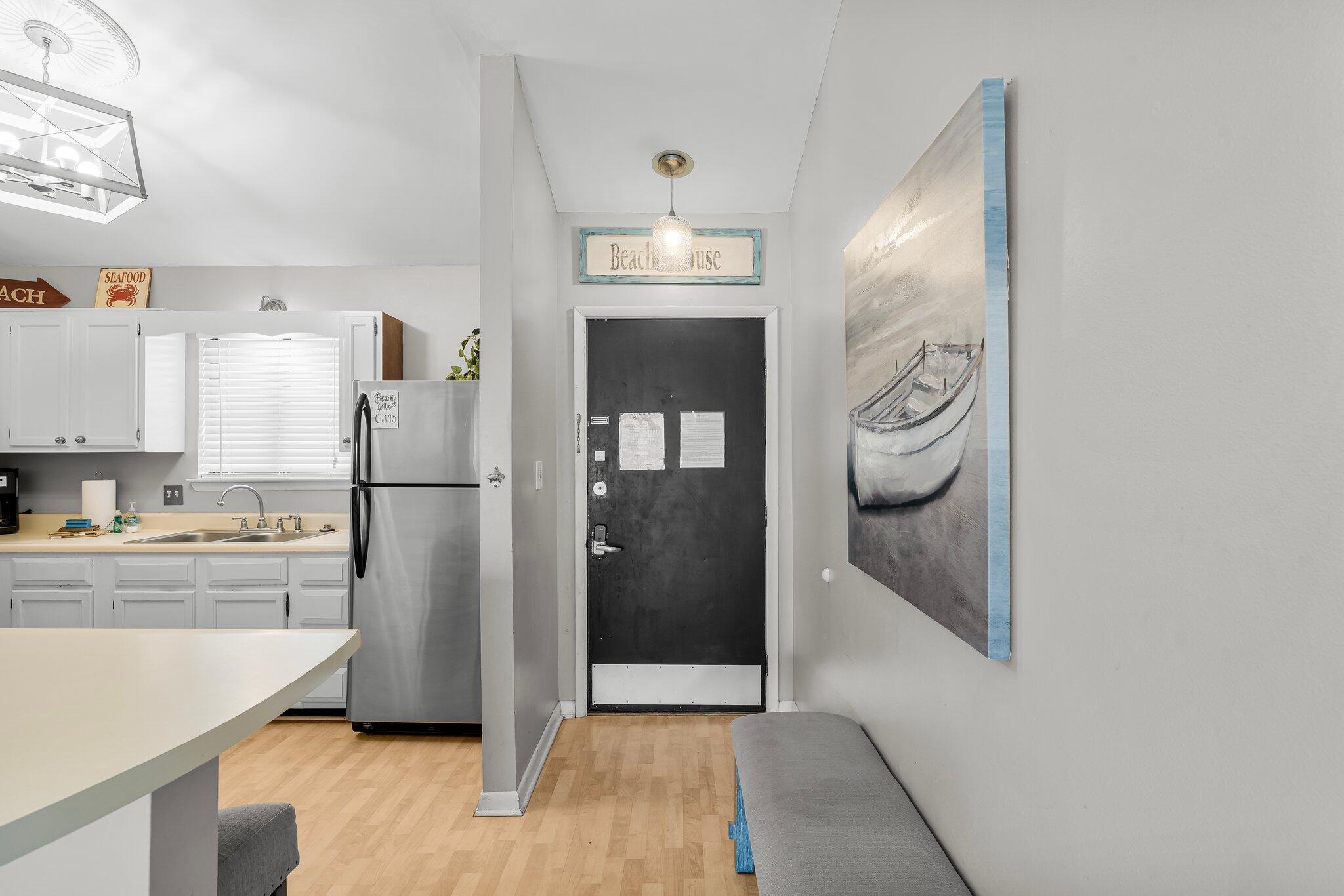 a kitchen with a refrigerator and cabinets