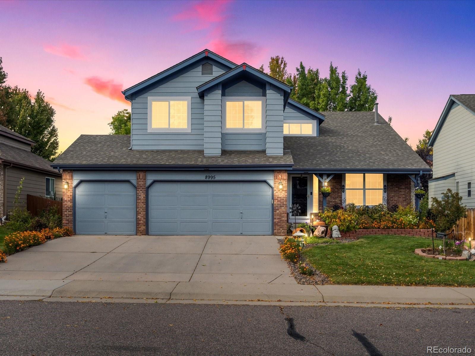 a front view of a house with a yard and garage